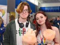 Young male and female holding candyfloss
