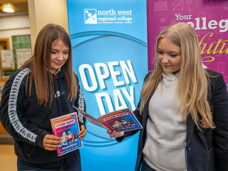 One school girls looking at a college open day guide