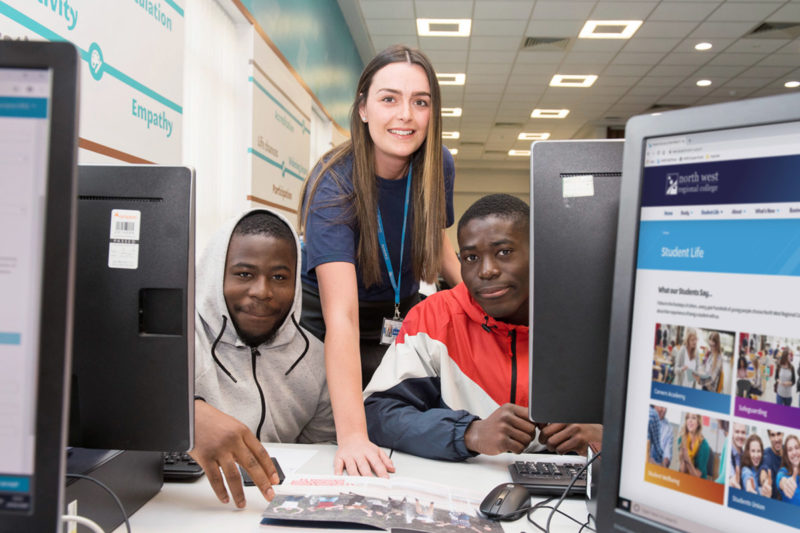 Male students getting help from a member of staff at Open Day